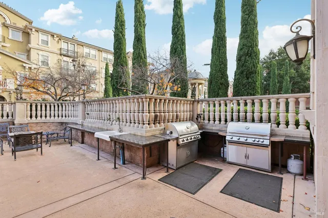 a view of a patio with a table and chairs
