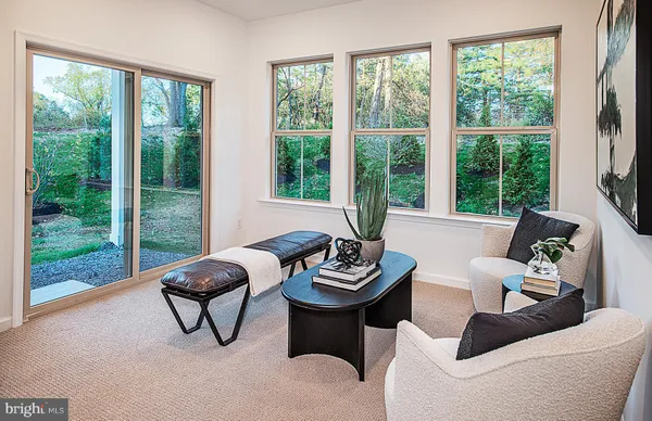 a living room with furniture and a floor to ceiling window