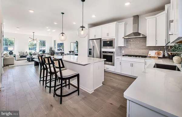 a large kitchen with a table and chairs