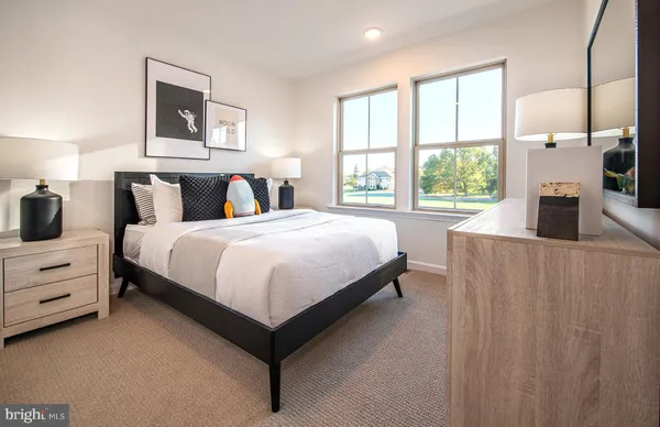 a bedroom with a bed and a large window