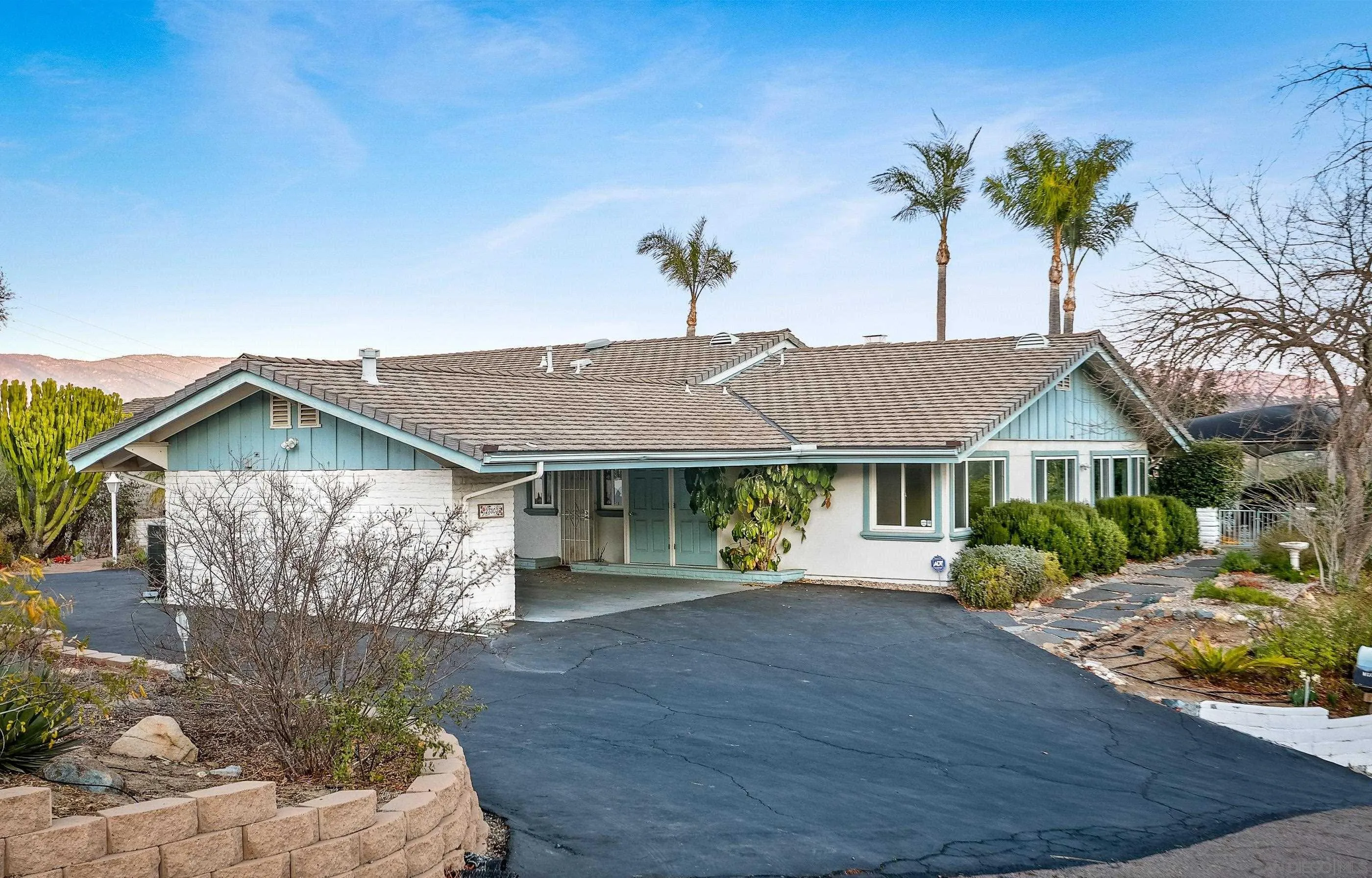 27303 Cool Water Ranch Road Valley Center, CA 92082 - Photo 1 of 30 a front view of a house with a garden