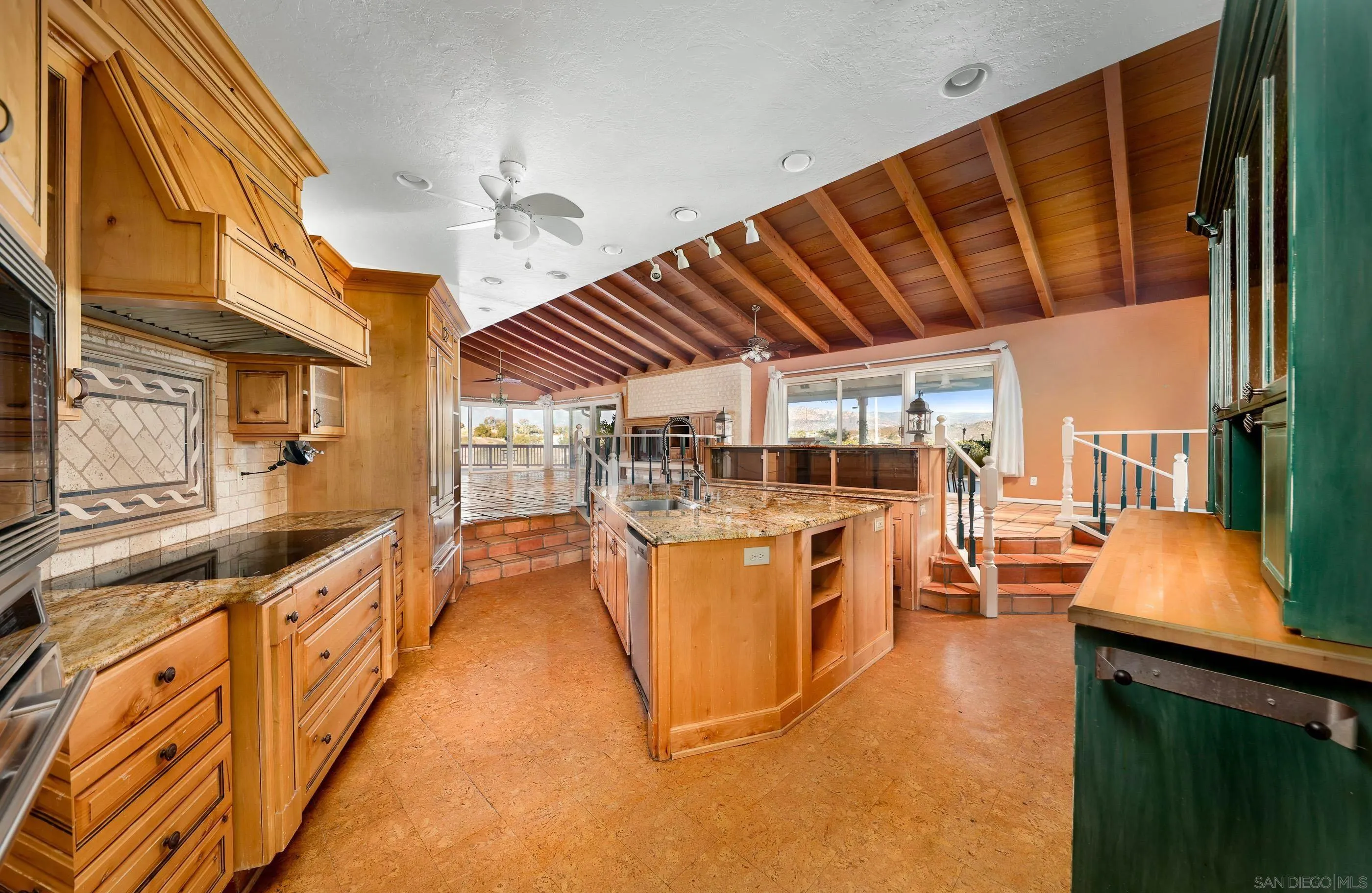 27303 Cool Water Ranch Road Valley Center, CA 92082 - Photo 18 of 30 a view of a kitchen with kitchen island granite countertop lots of counter top space