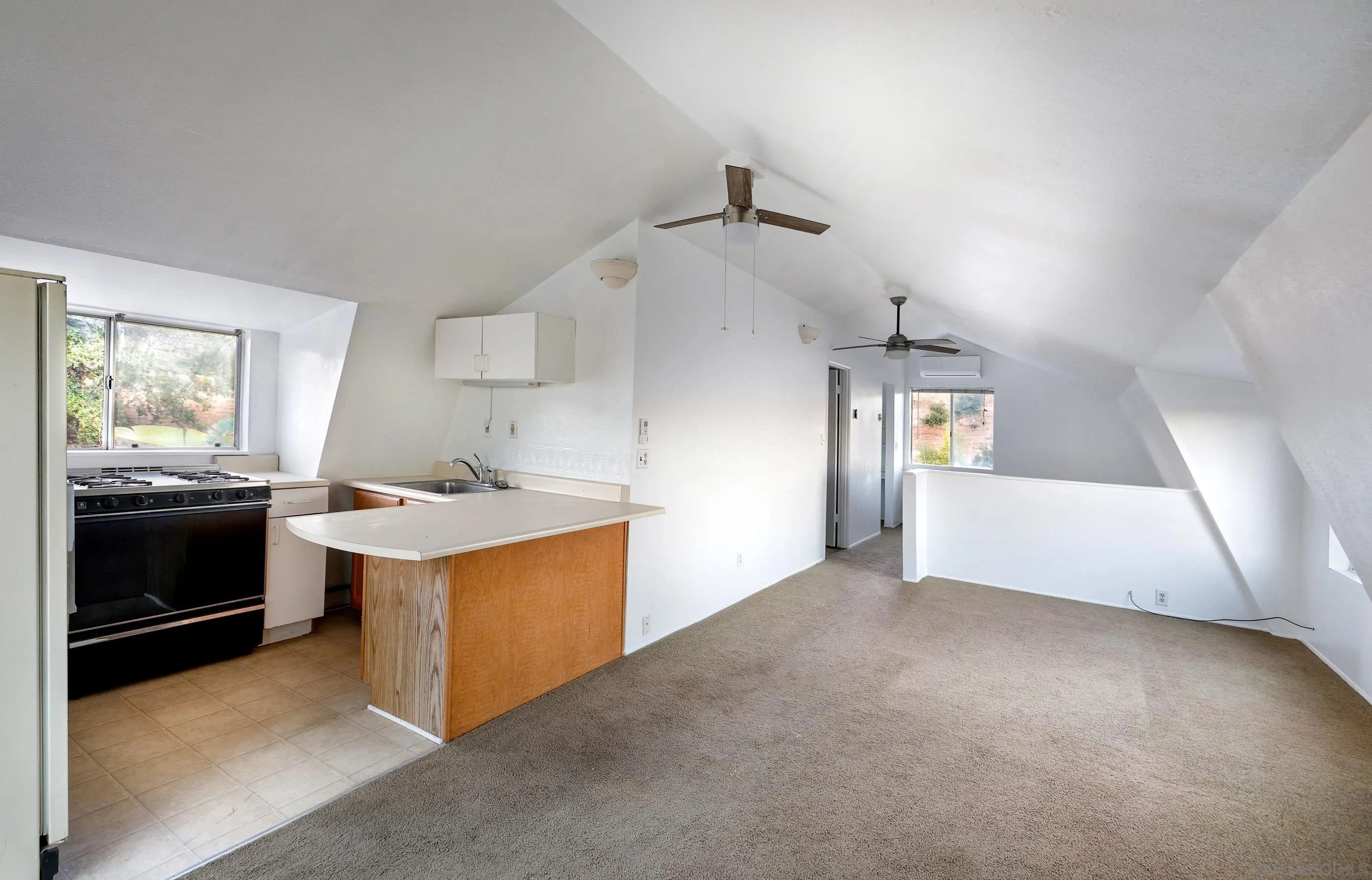 27303 Cool Water Ranch Road Valley Center, CA 92082 - Photo 26 of 30 an empty room with a kitchen and a stove top oven