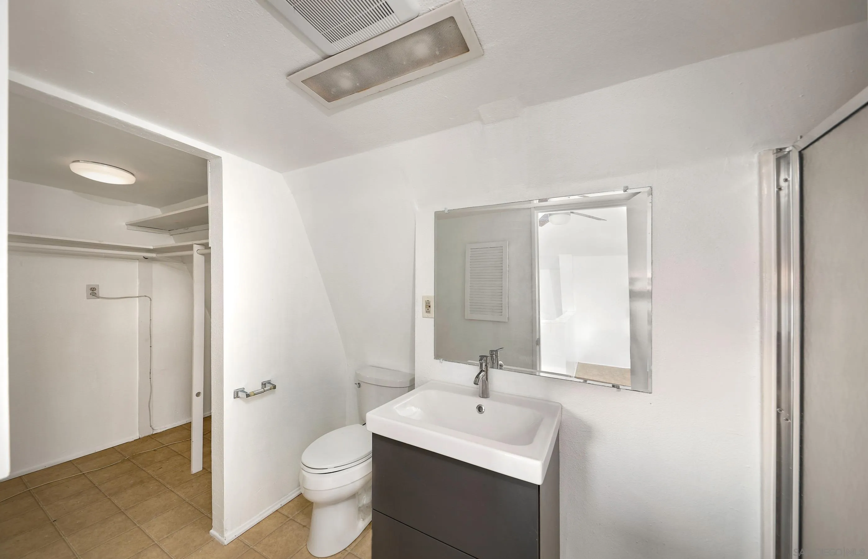 27303 Cool Water Ranch Road Valley Center, CA 92082 - Photo 27 of 30 a bathroom with a toilet a sink a mirror and vanity