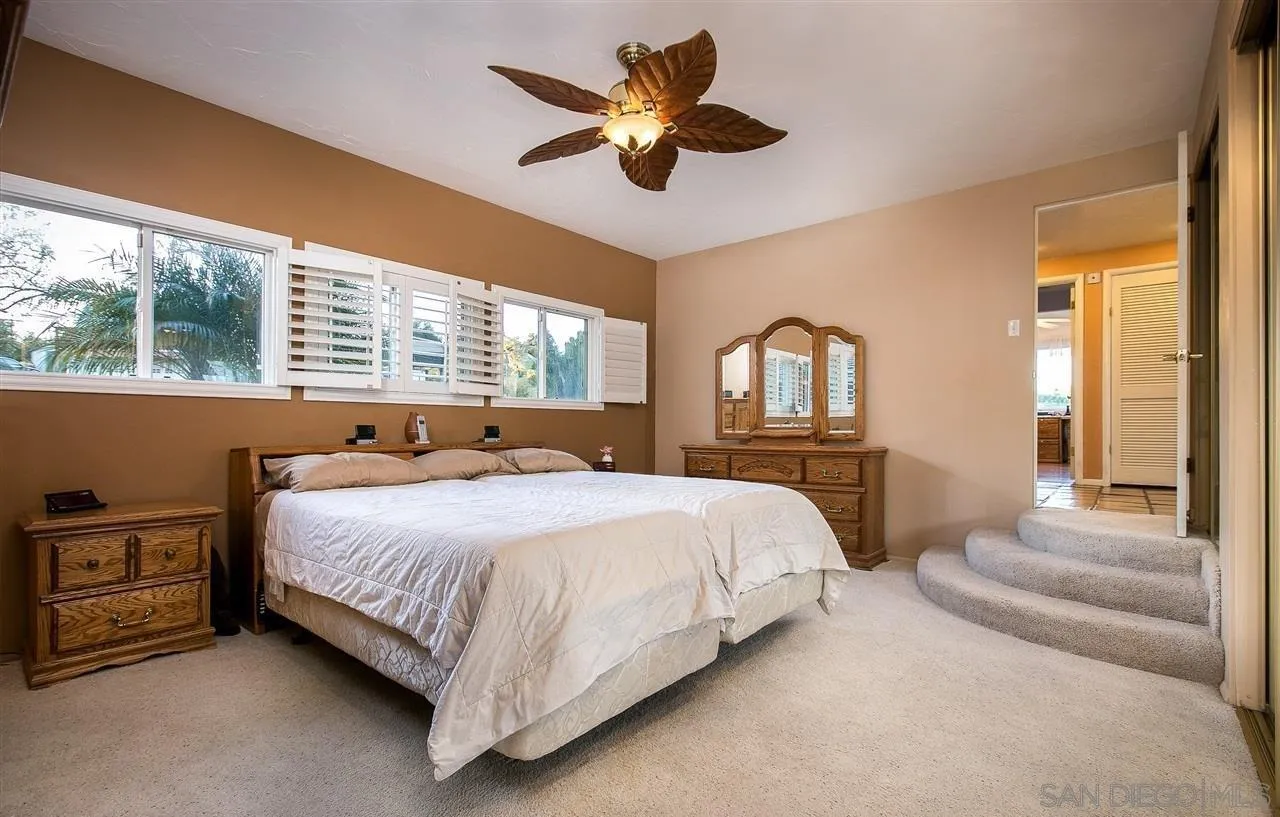 27303 Cool Water Ranch Road Valley Center, CA 92082 - Photo 9 of 30 a bedroom with a bed ceiling fan and a large window