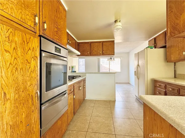 a kitchen with cabinets and stainless steel appliances