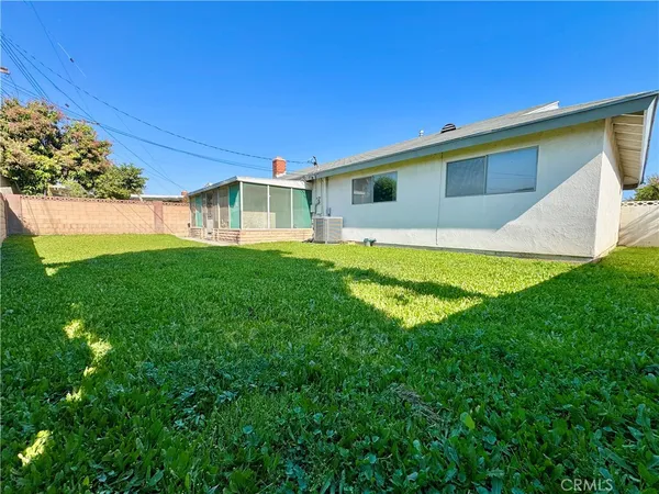a view of a backyard with plants and a patio