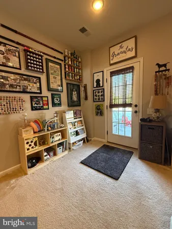 a living room with furniture a flat screen tv and windows