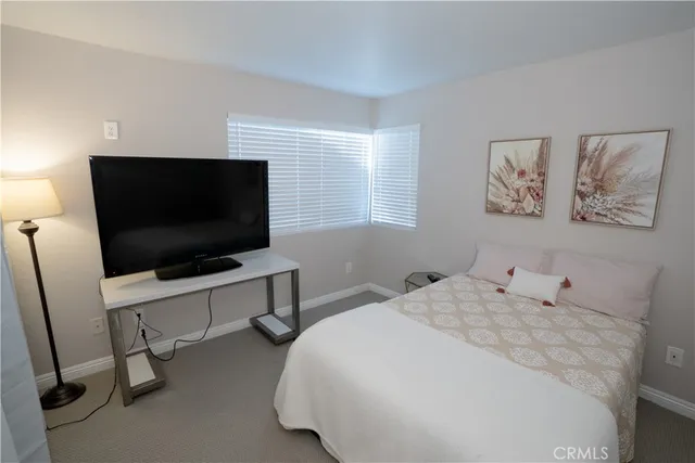 a bedroom with a bed and a curtain