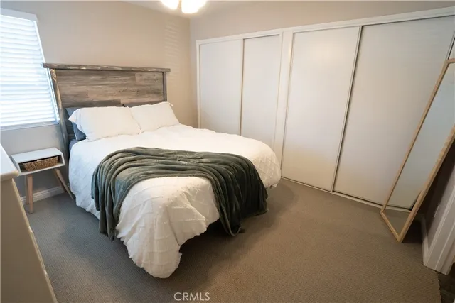 a bedroom with a bed and a mirror