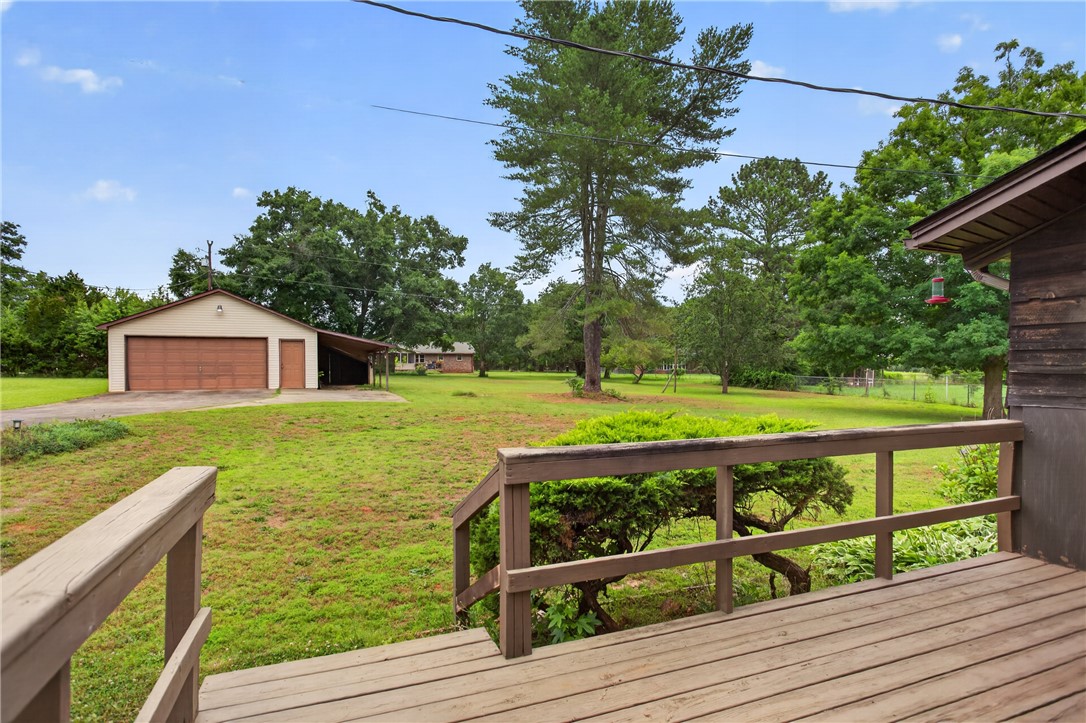 112 Holliday Lane Pendleton, SC 29670 - Photo 32 of 42 A spacious backyard with mature trees and a detached garage offers ample outdoor living.