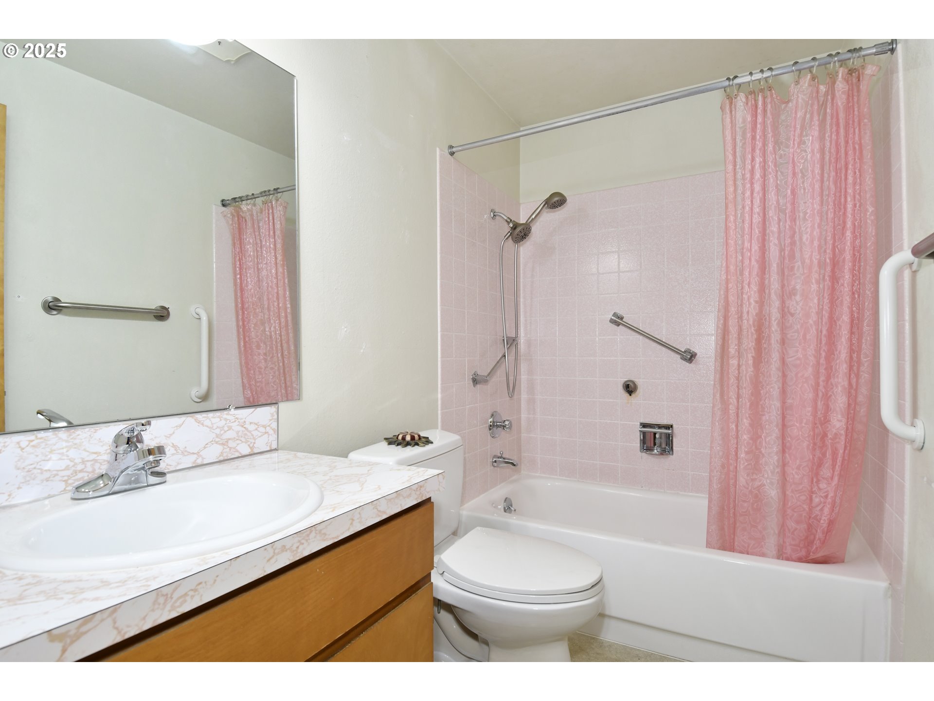 579 Northeast Fleming Avenue, Unit C41 Gresham, OR 97030 - Photo 15 of 32 a bathroom with a sink a toilet a mirror a bathtub and shower