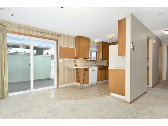 a kitchen with stainless steel appliances kitchen island granite countertop a refrigerator and a sink