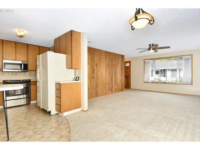 a view of a kitchen with a stove top oven