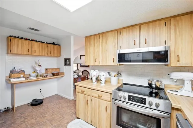 a kitchen with a cabinets and appliances