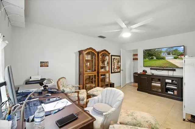 a living room with furniture a flat screen tv and gym equipment