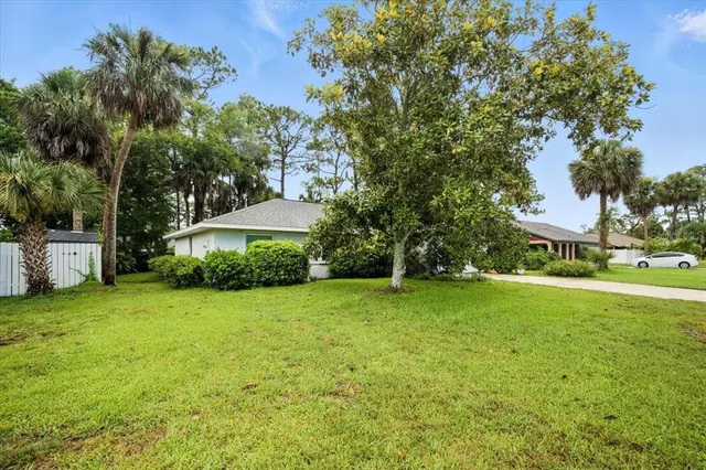 a view of a house with a backyard