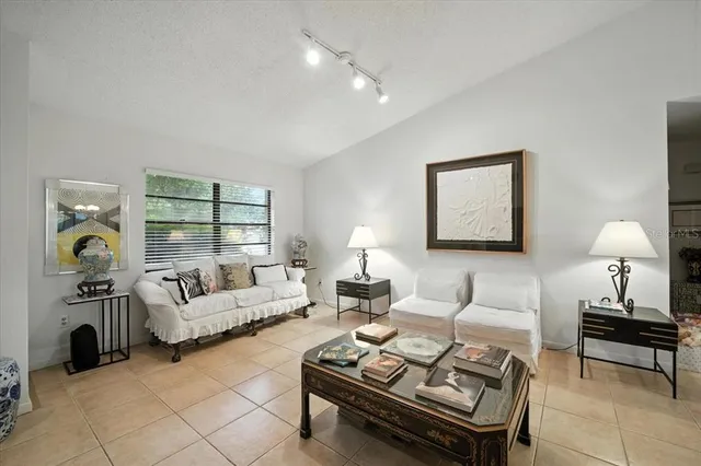 a living room with furniture and a lamp
