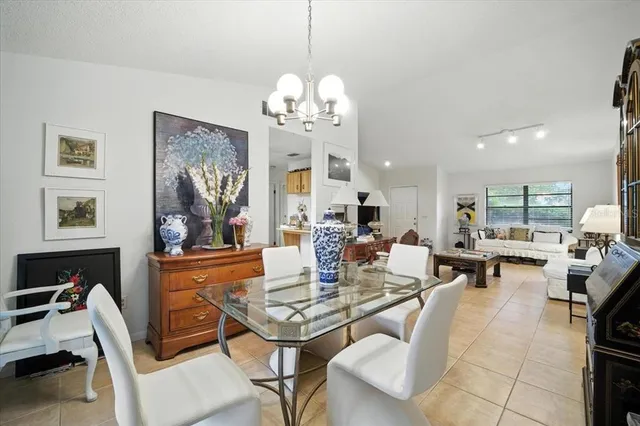 a living room with fireplace furniture and a chandelier