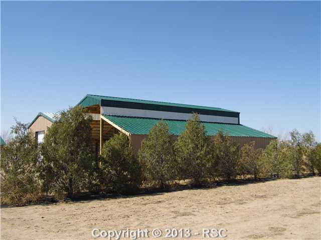 1450 Buck Road Calhan, CO 80808 - Photo 21 of 25 There are many trees planted and growing. Trees are planted and include fruit, shade and wind blocks such as the one shown above.