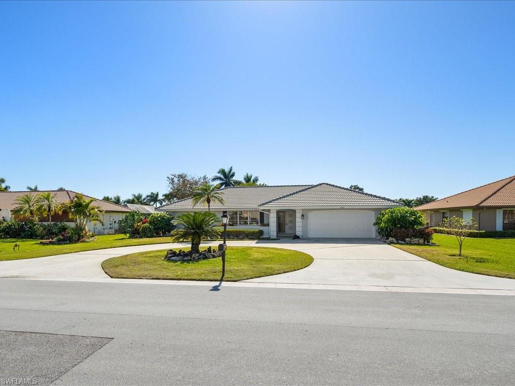 262 Torrey Pines Point Naples, FL 34113 - Photo 1 of 24 a view of a swimming pool with a lounge chairs