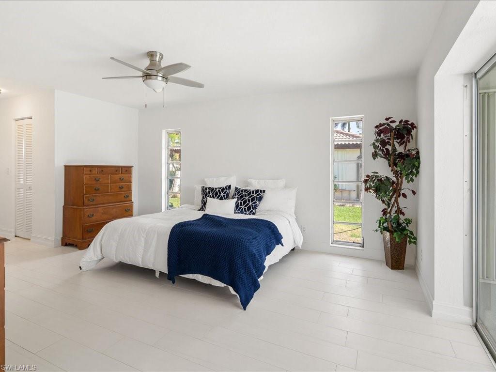 262 Torrey Pines Point Naples, FL 34113 - Photo 11 of 24 a bedroom with a bed and a window