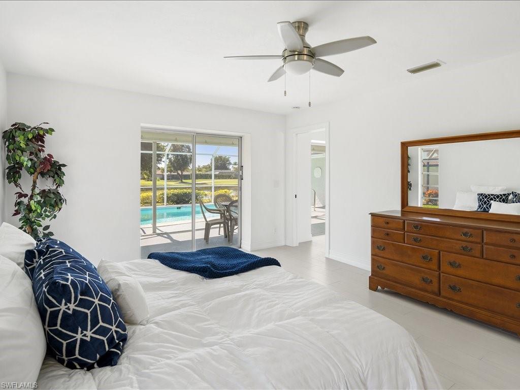 262 Torrey Pines Point Naples, FL 34113 - Photo 12 of 24 a bedroom with a bed and a chandelier