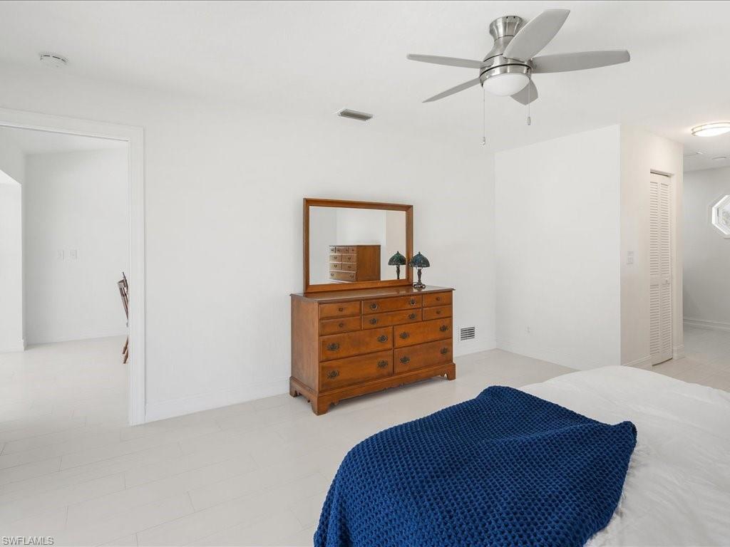 262 Torrey Pines Point Naples, FL 34113 - Photo 13 of 24 a bedroom with a bed and a dresser