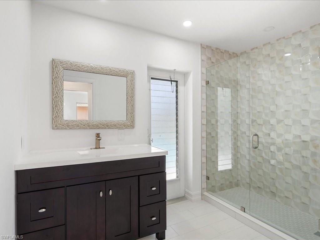 262 Torrey Pines Point Naples, FL 34113 - Photo 18 of 24 a bathroom with a sink vanity and mirror