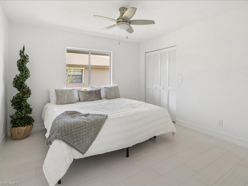 262 Torrey Pines Point Naples, FL 34113 - Photo 19 of 24 a bedroom with a bed and a potted plant