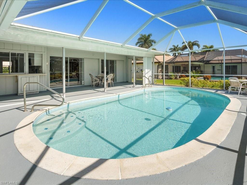 262 Torrey Pines Point Naples, FL 34113 - Photo 23 of 24 front view of a house with a swimming pool
