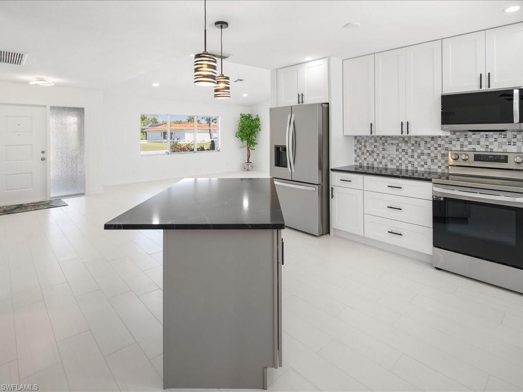 262 Torrey Pines Point Naples, FL 34113 - Photo 3 of 24 a kitchen with stainless steel appliances a refrigerator sink and microwave