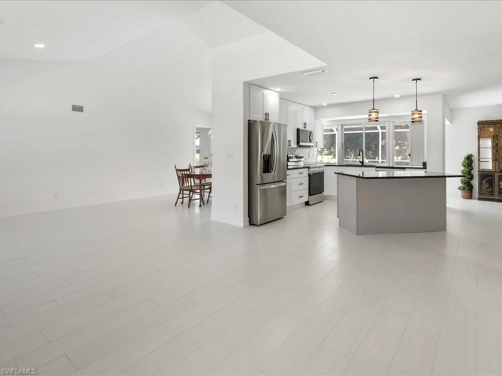 262 Torrey Pines Point Naples, FL 34113 - Photo 6 of 24 a kitchen with refrigerator and cabinets