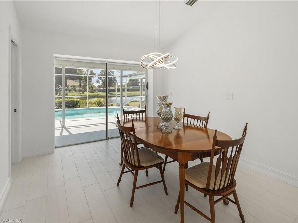262 Torrey Pines Point Naples, FL 34113 - Photo 7 of 24 a view of a dining room with furniture and wooden floor