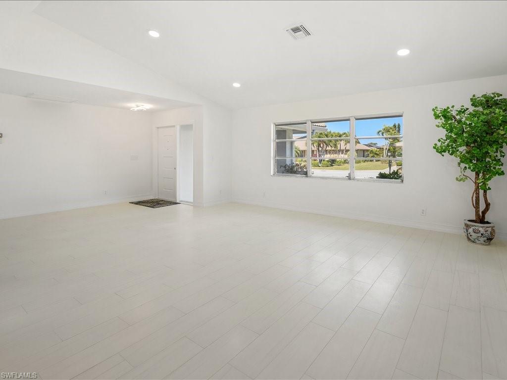 262 Torrey Pines Point Naples, FL 34113 - Photo 9 of 24 an empty room with potted plant and windows