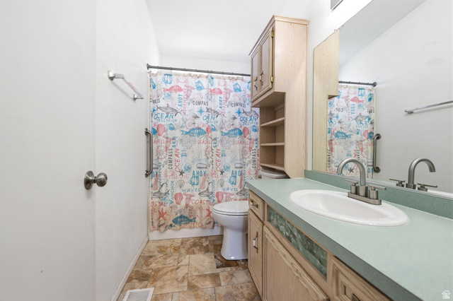 2491 Highway 89, Unit 614 Pleasant View, UT 84404 - Photo 20 of 27 Vanity with an integrated sink and mirror, providing counter space and storage