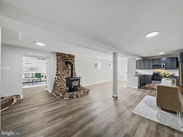 a living room with furniture and kitchen view