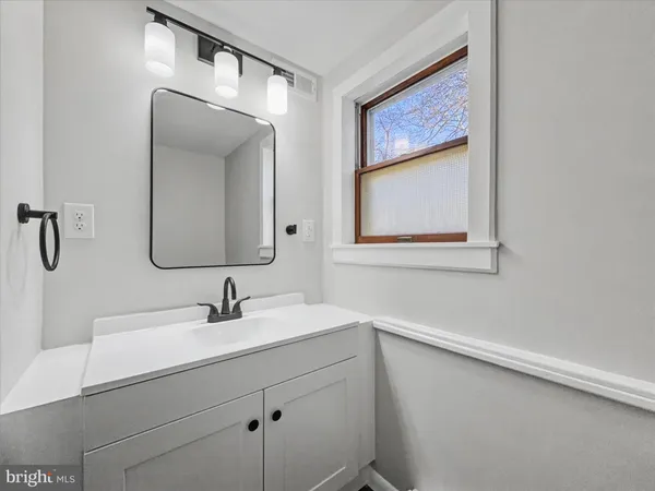 a bathroom with a sink mirror and vanity