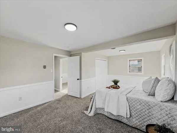 a bedroom with a white bed and a shower