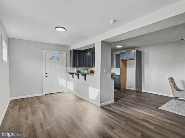 a view of a livingroom with wooden floor and furniture