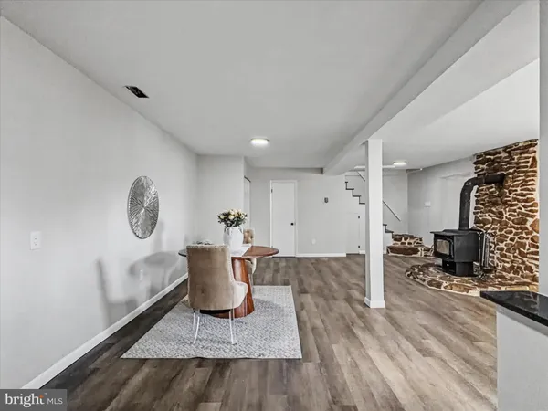 a view of workspace filled with furniture and wooden floor