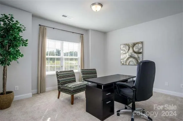 a view of a workspace with furniture and a potted plant