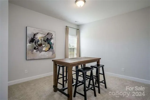 a view of a dining room with furniture and window