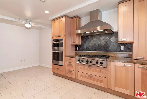 a kitchen with granite countertop a stove and a sink