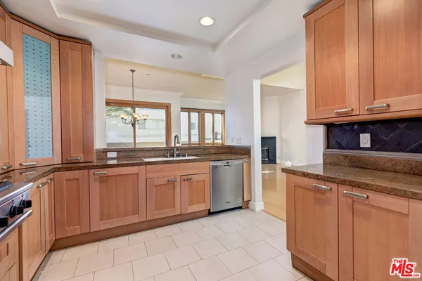 a kitchen with granite countertop a sink and cabinets