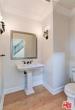 a bathroom with a sink toilet and mirror