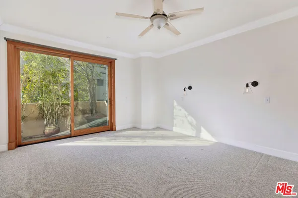 a view of a livingroom with an empty space and balcony ceiling fan