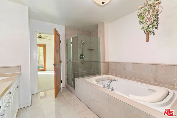 a bathroom with a bathtub and a shower