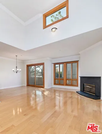 a view of an empty room with a fireplace and a window