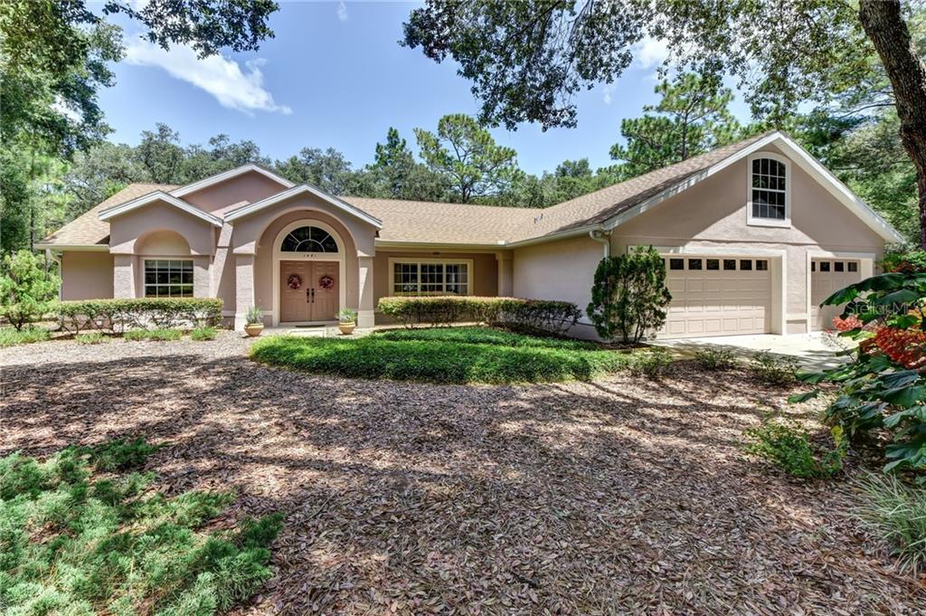 1481 Rockingham Lane DeLand, FL 32724 - Photo 1 of 1 a front view of a house with a garden
